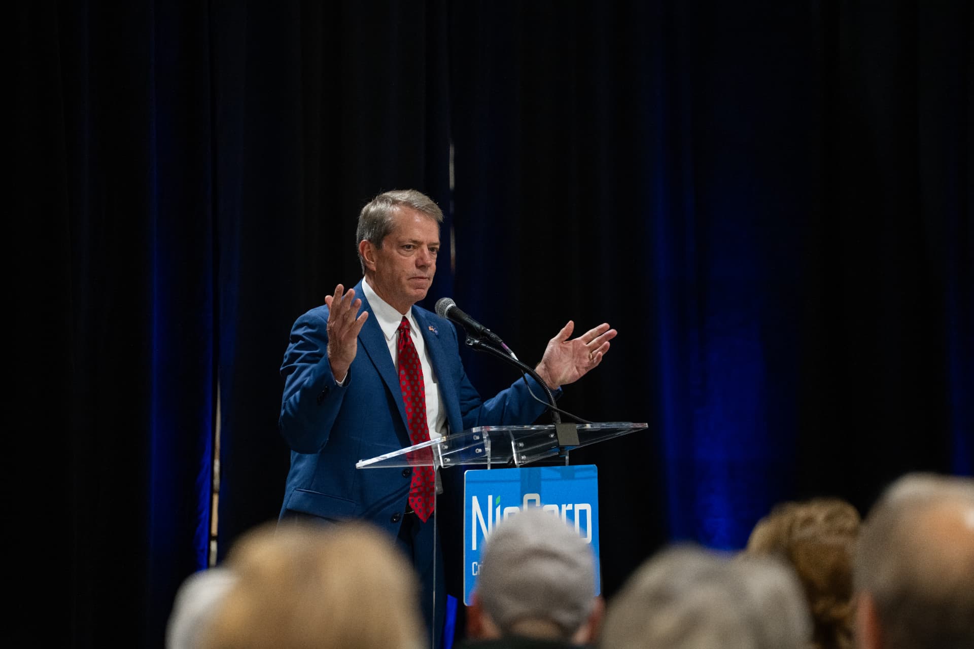 NioCorp town hall speaker addressing an audience from a clear lectern
